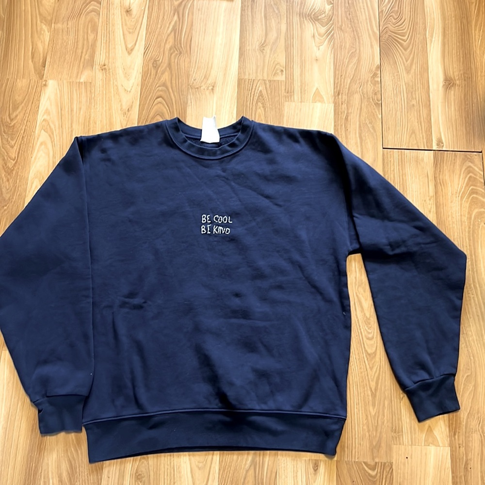 Navy long sleeve sweatshirt with “Be Cool Be Kind”